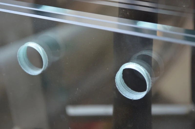 Round holes drilled in 10mm toughened pool fence glass Round holes drilled in 10mm toughened pool fence glass